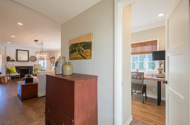 a dining room with furniture a chandelier and wooden floor