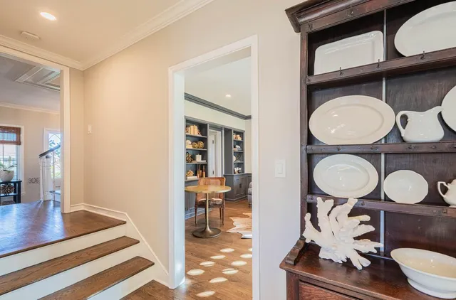 a dining room with furniture a fireplace and wooden floor