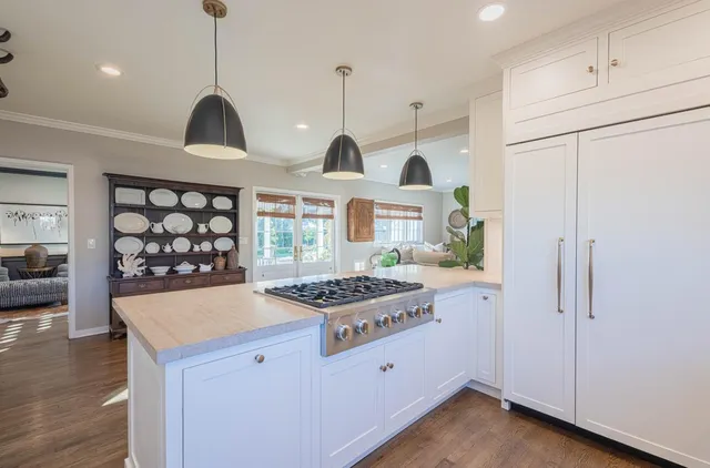 a bedroom with a large bed and a potted plant