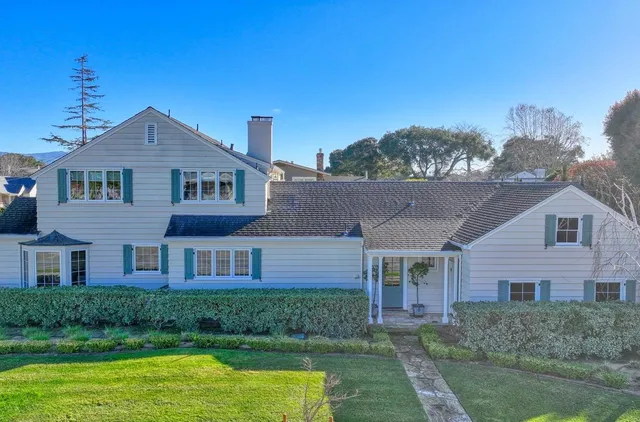 a front view of a house with garden