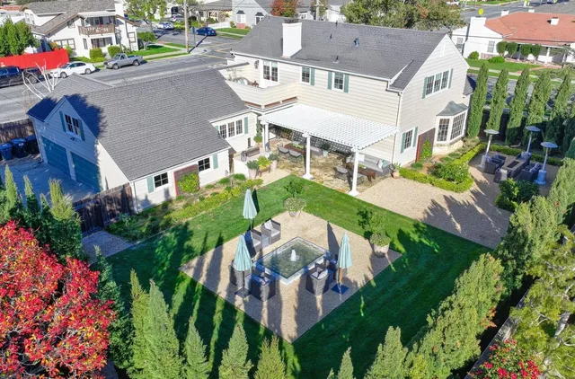 a living room with furniture a fireplace and a chandelier