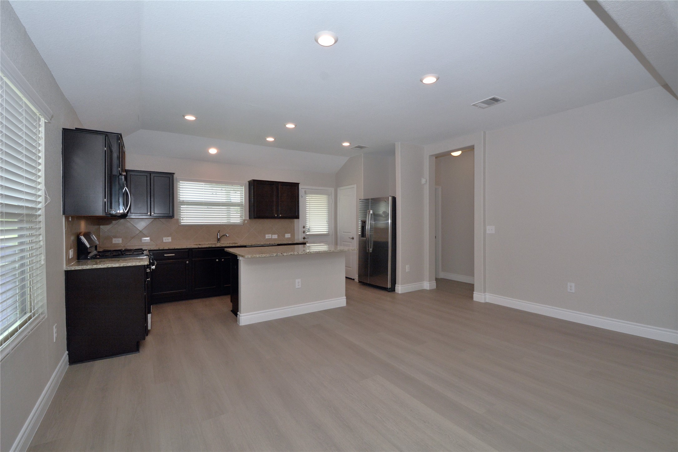 3901 Colorado High Avenue Austin, TX 78744 - Photo 11 of 39 a large kitchen with a large counter top appliances and cabinets