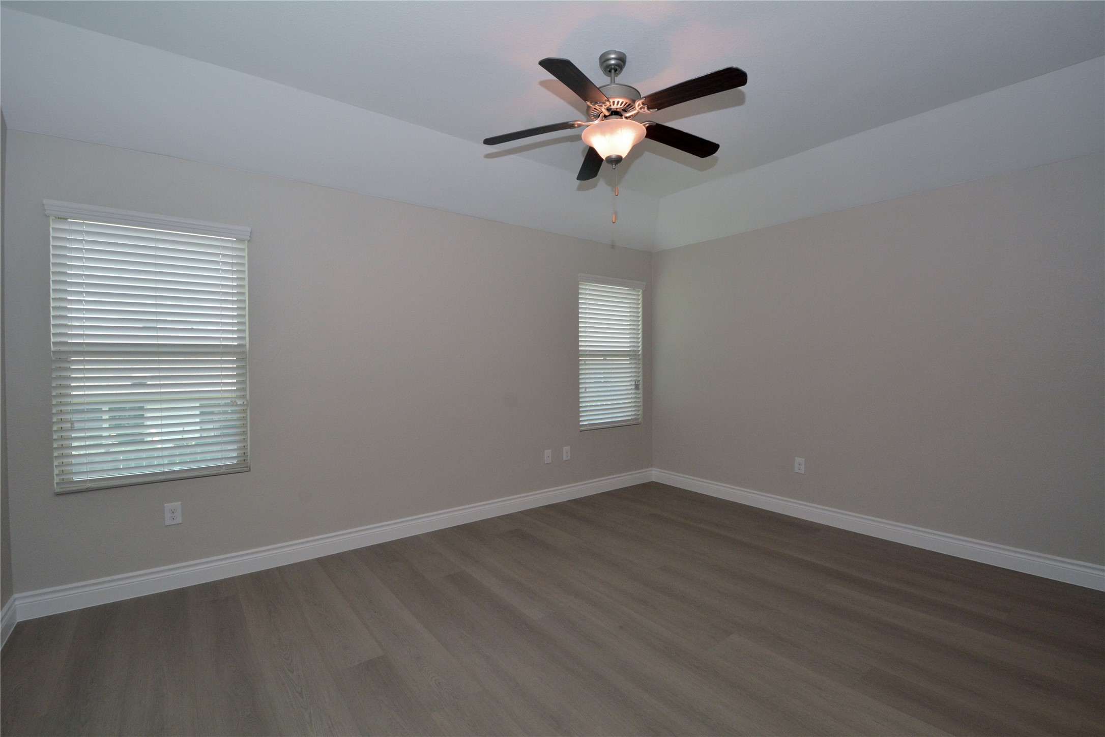 3901 Colorado High Avenue Austin, TX 78744 - Photo 12 of 39 an empty room with wooden floor and windows
