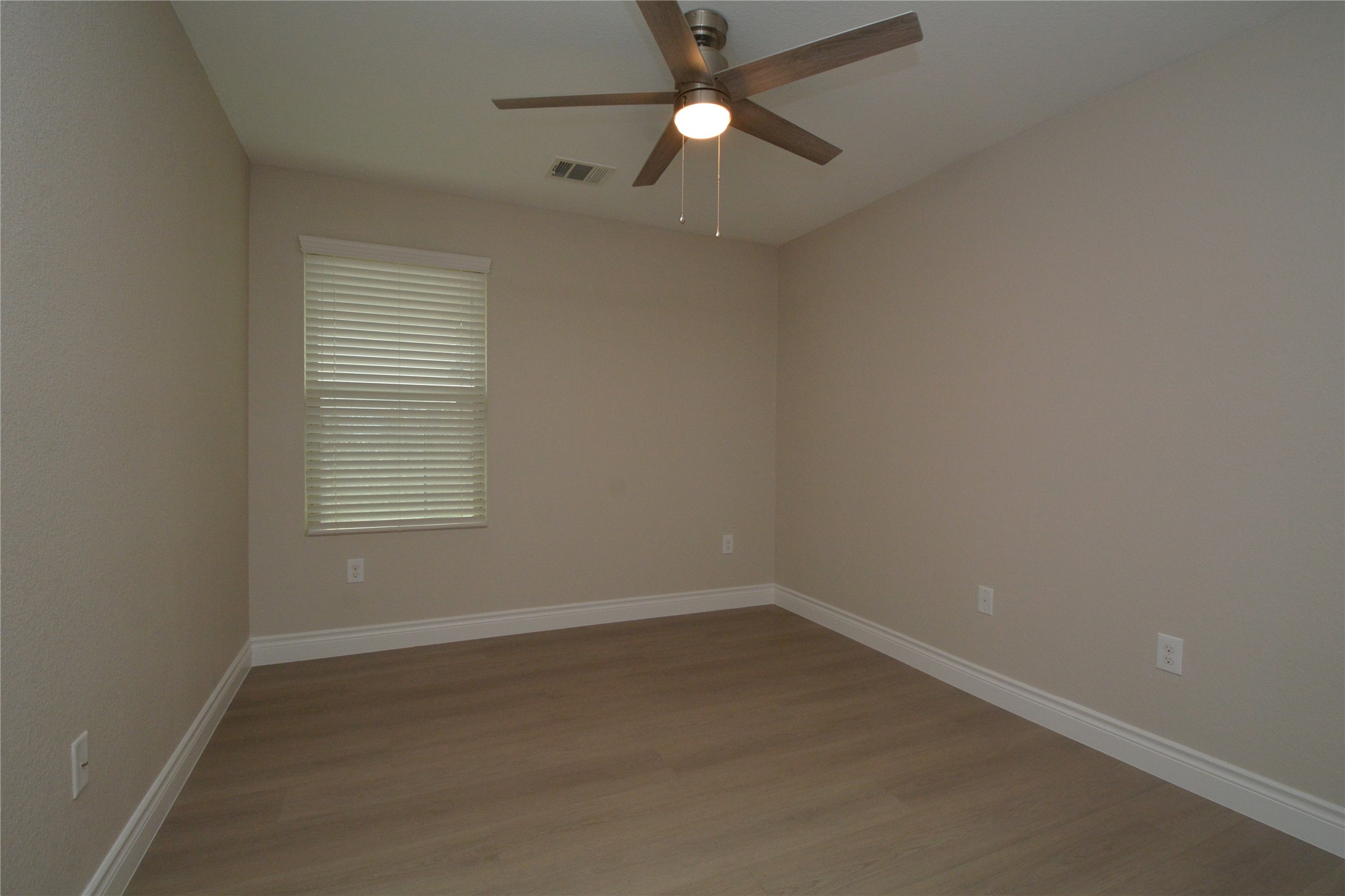 3901 Colorado High Avenue Austin, TX 78744 - Photo 23 of 39 an empty room with a window and a fan