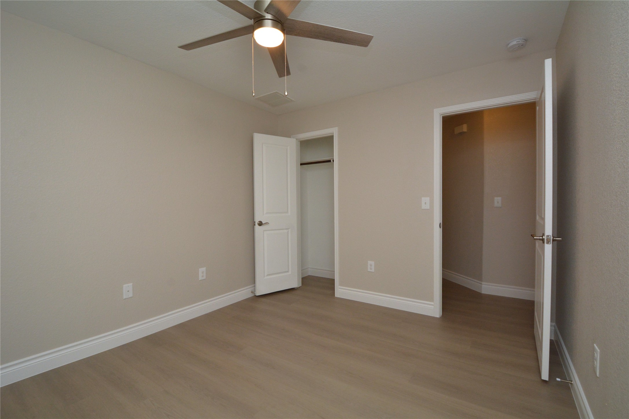3901 Colorado High Avenue Austin, TX 78744 - Photo 24 of 39 an empty room with a ceiling fan and a window