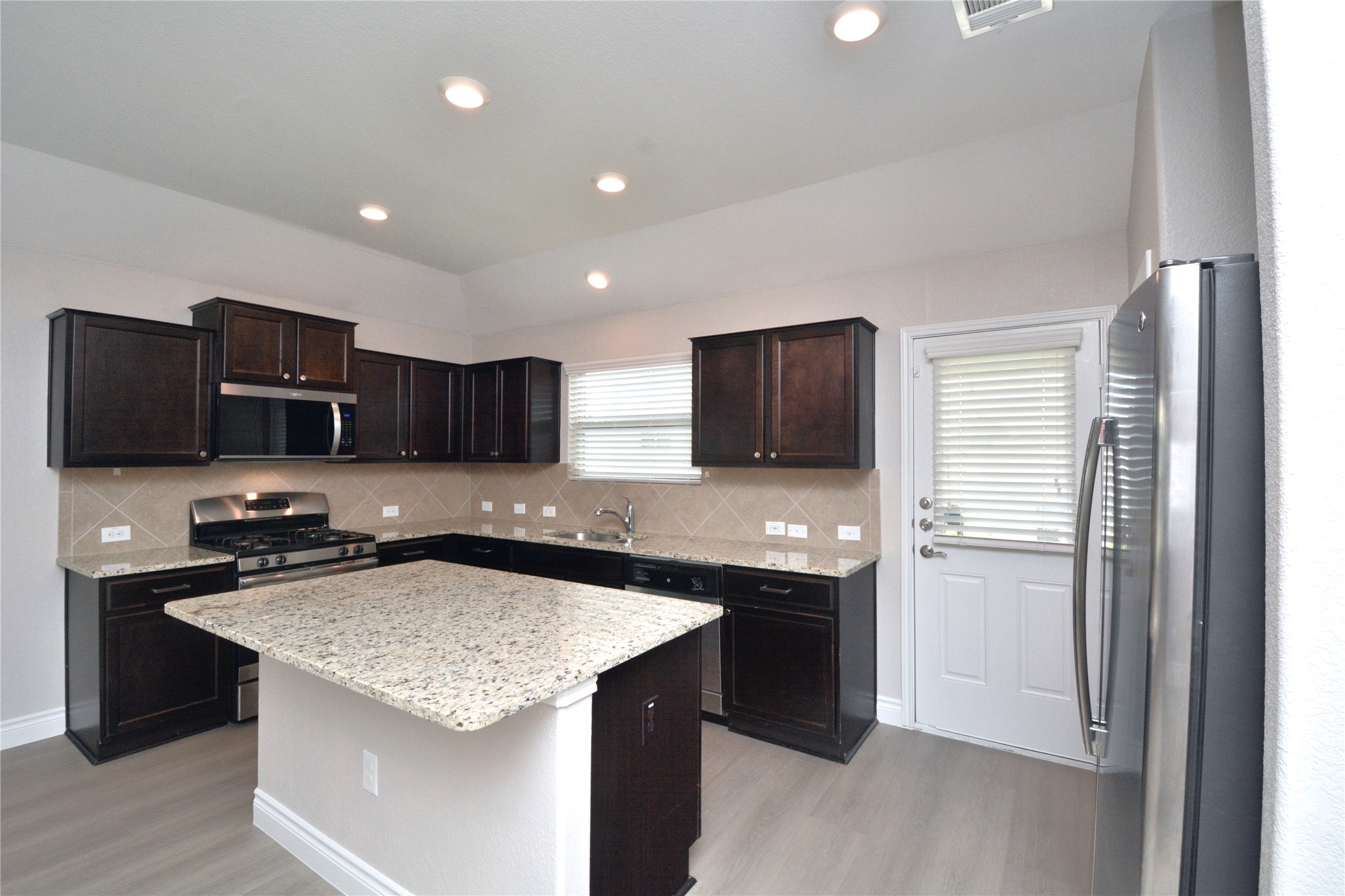3901 Colorado High Avenue Austin, TX 78744 - Photo 4 of 39 a kitchen with stainless steel appliances granite countertop a sink stove and refrigerator