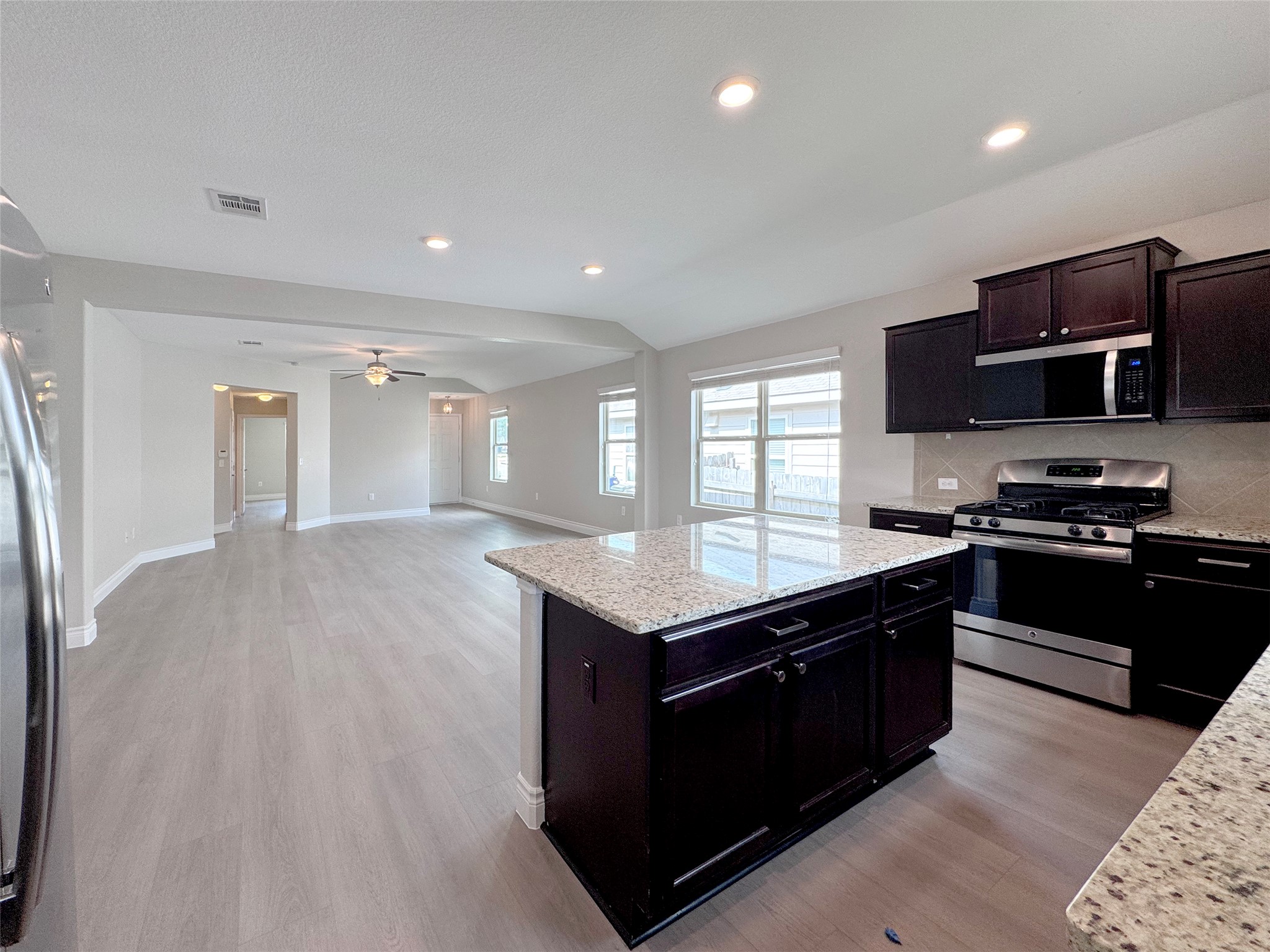 3901 Colorado High Avenue Austin, TX 78744 - Photo 8 of 39 a kitchen with stainless steel appliances granite countertop a stove a sink and a microwave