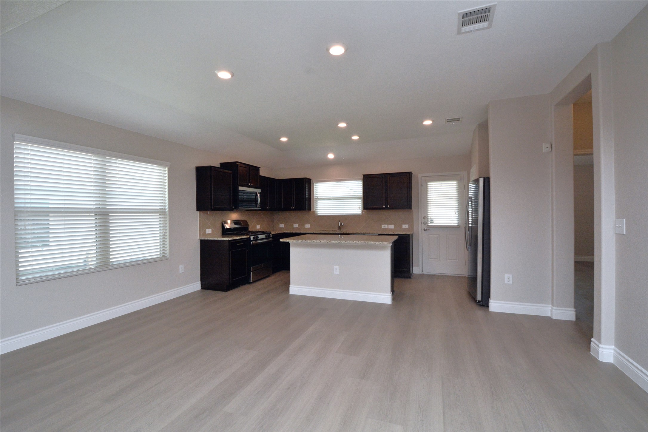 3901 Colorado High Avenue Austin, TX 78744 - Photo 10 of 39 a view of kitchen with kitchen island granite countertop stainless steel appliances stove sink and cabinets