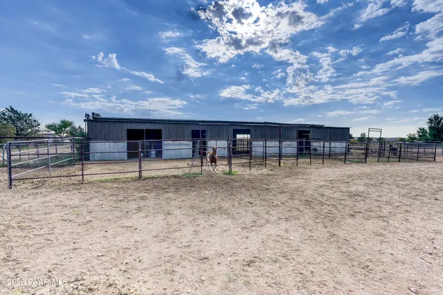 a view of a house with backyard porch and sitting area