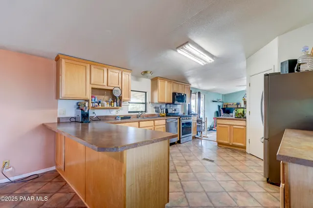 a kitchen with stainless steel appliances granite countertop a refrigerator sink and cabinets
