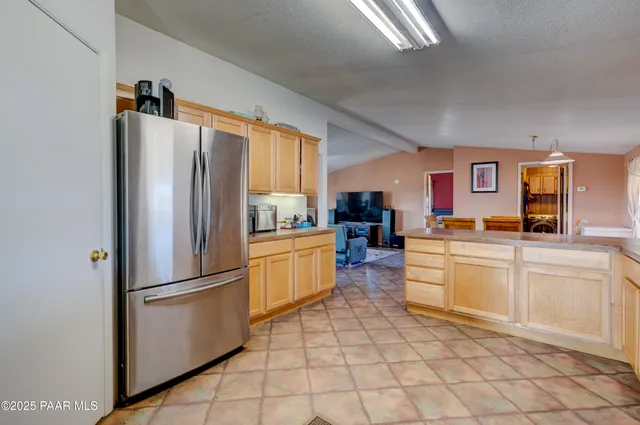 a kitchen with stainless steel appliances a refrigerator sink and cabinets