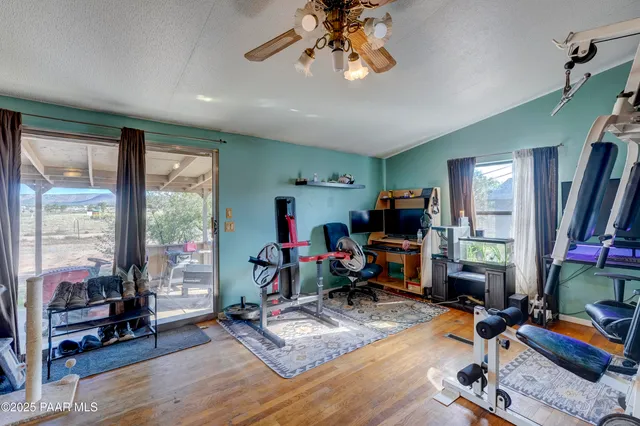 a room with lots of furniture and view of kitchen