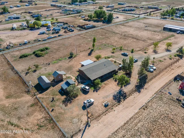 an aerial view of house with yard and parking