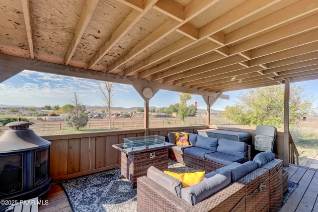 a view of a swimming pool with a couches chairs and a patio