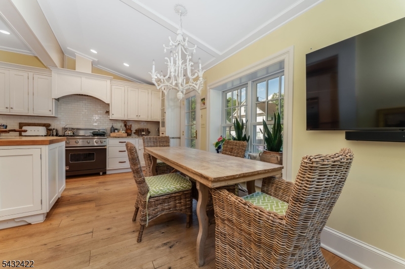 11 New Street Mendham, NJ 07945 - Photo 9 of 35 a kitchen with stainless steel appliances a table chairs and a chandelier