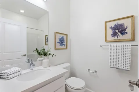 a bathroom with a toilet a sink and mirror
