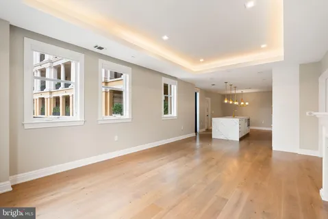 a view of a livingroom with wooden floor and white walls