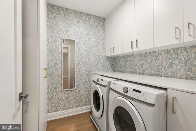 an empty room with wooden floor and a window