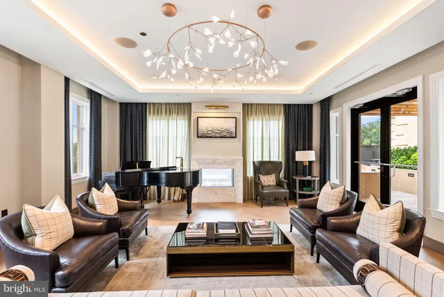 a living room with furniture and large windows