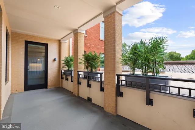 a view of a porch with wooden floor and fence