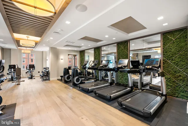 a view of a room with gym equipment and large windows