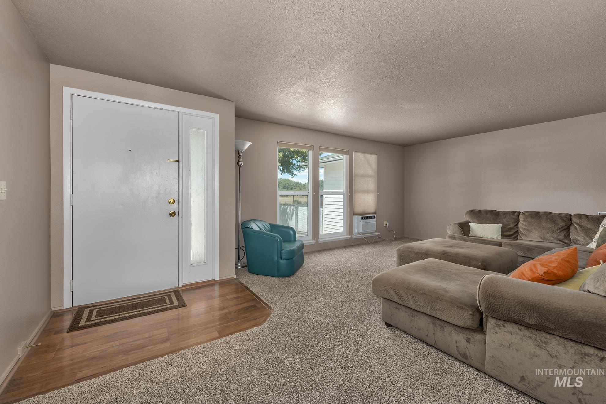 885 Airport Road Vale, OR 97918 - Photo 4 of 36 Carpeted foyer entrance with a textured ceiling and wood finished floors