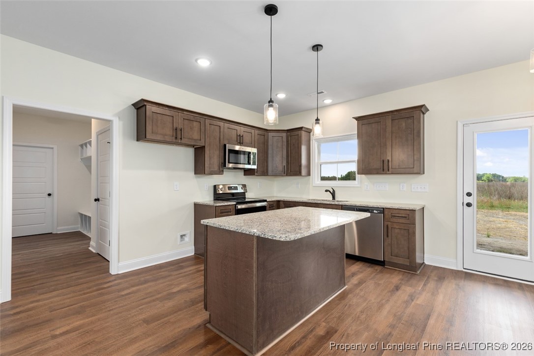 195 Barberry Road Raeford, NC 28376 - Photo 14 of 30 a kitchen with stainless steel appliances granite countertop a sink stove and refrigerator
