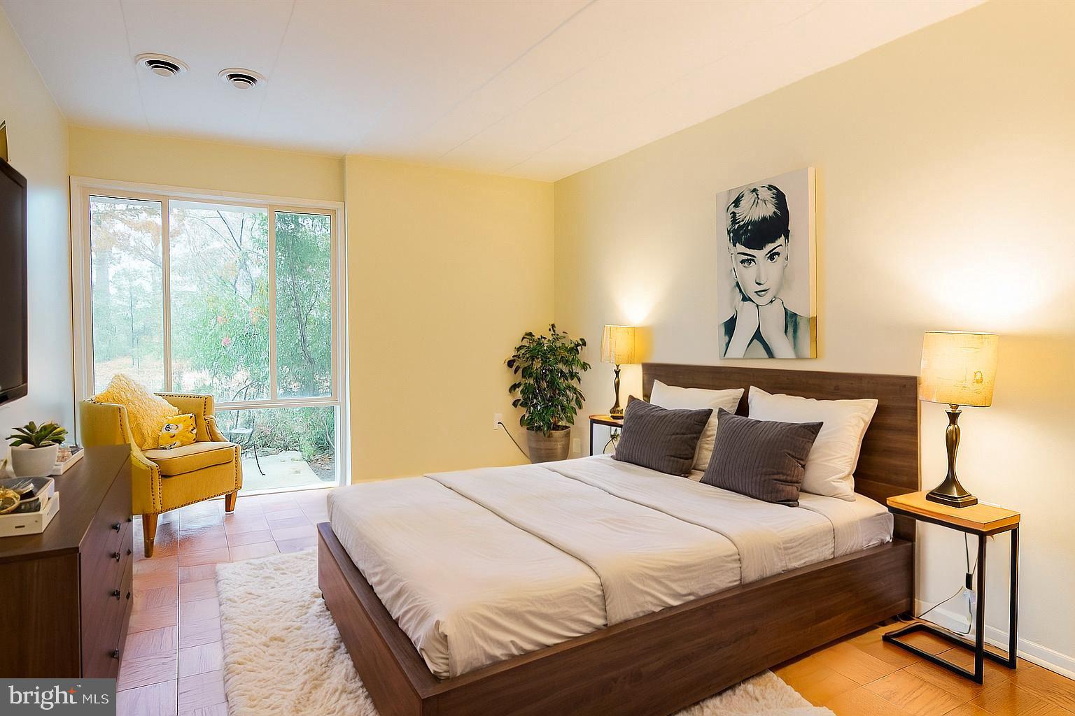 2605 Redcoat Drive, Unit 252 Alexandria, VA 22303 - Photo 4 of 26 a bedroom with a bed and wooden floor