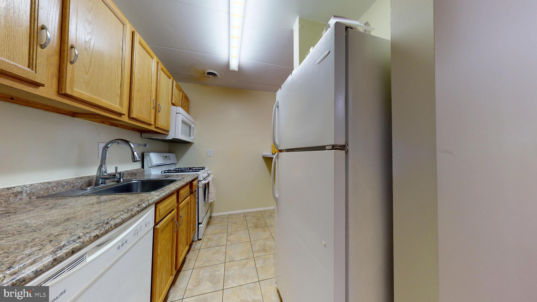 2605 Redcoat Drive, Unit 252 Alexandria, VA 22303 - Photo 7 of 26 a kitchen with stainless steel appliances granite countertop a sink and a refrigerator