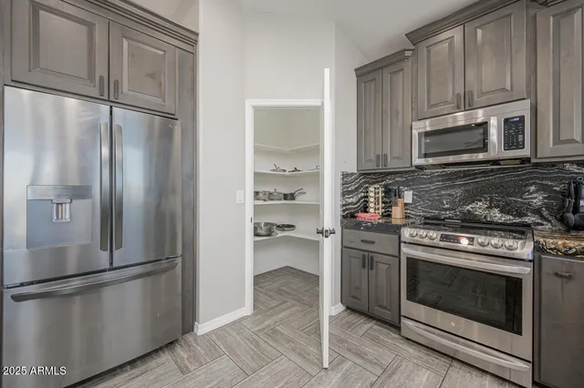a bathroom with a granite countertop sink toilet and mirror
