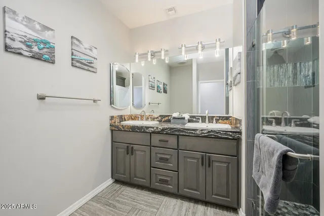 a bedroom with a bed and a ceiling fan