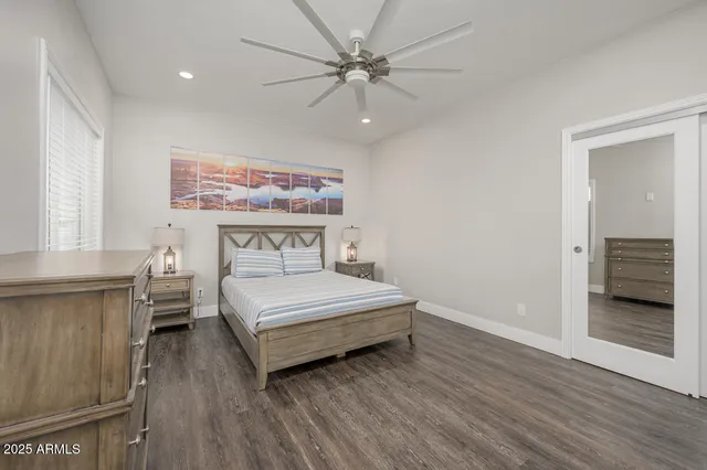 a bedroom with a bed and wooden floor