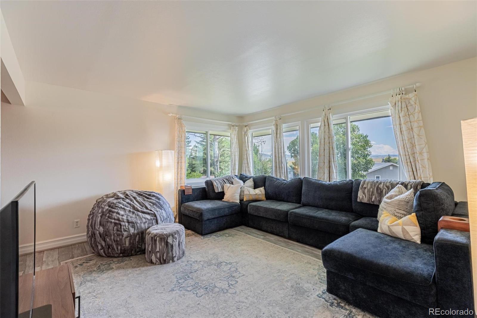 420 Clover Circle Hayden, CO 81639 - Photo 11 of 37 a living room with furniture and a large window