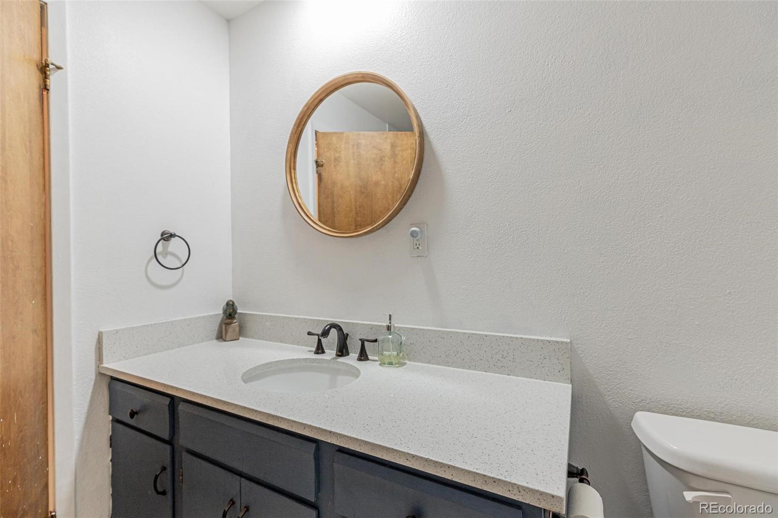 420 Clover Circle Hayden, CO 81639 - Photo 14 of 37 a bathroom with a sink a toilet and a mirror