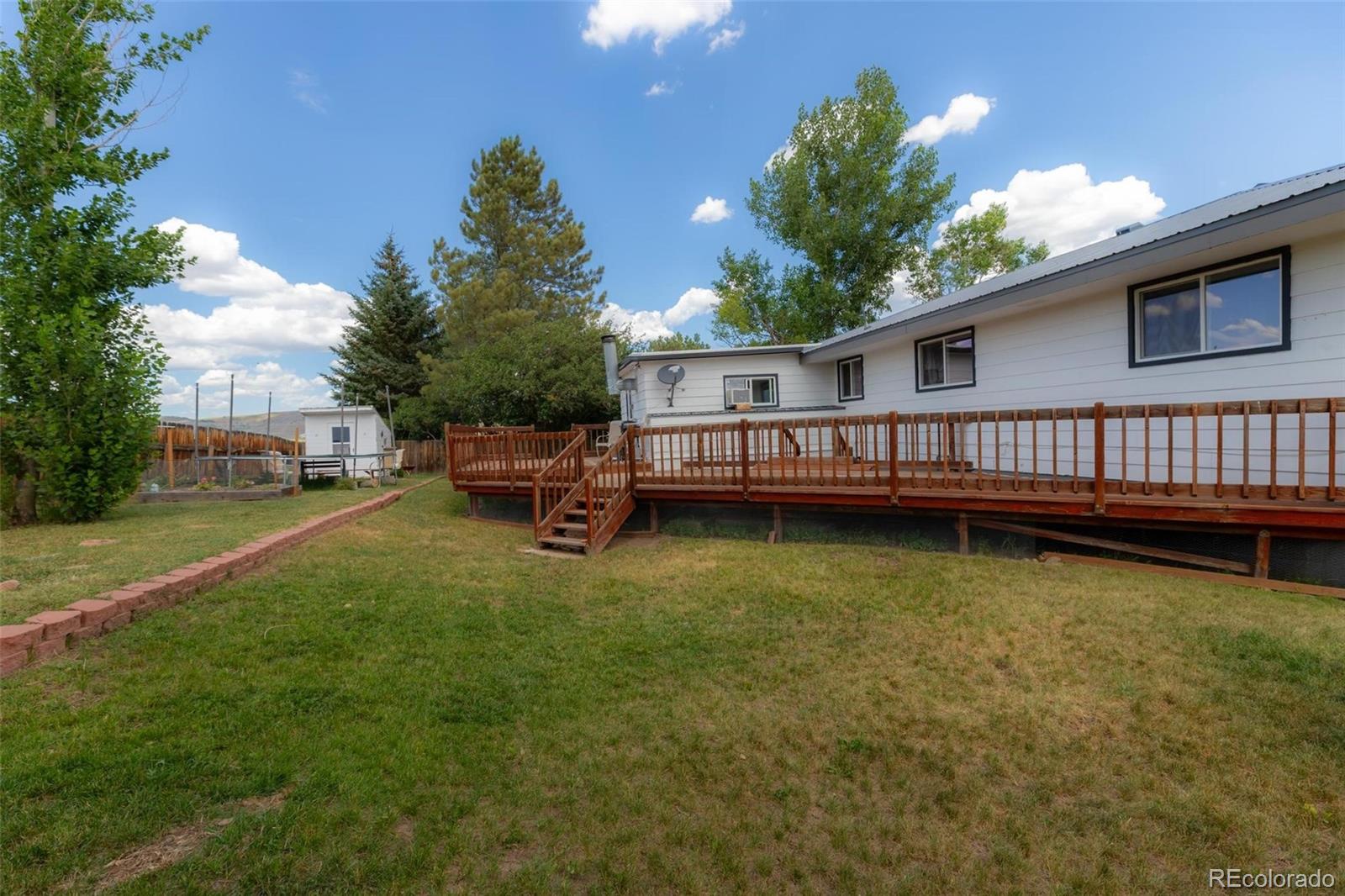 420 Clover Circle Hayden, CO 81639 - Photo 30 of 37 a view of a house with a wooden deck