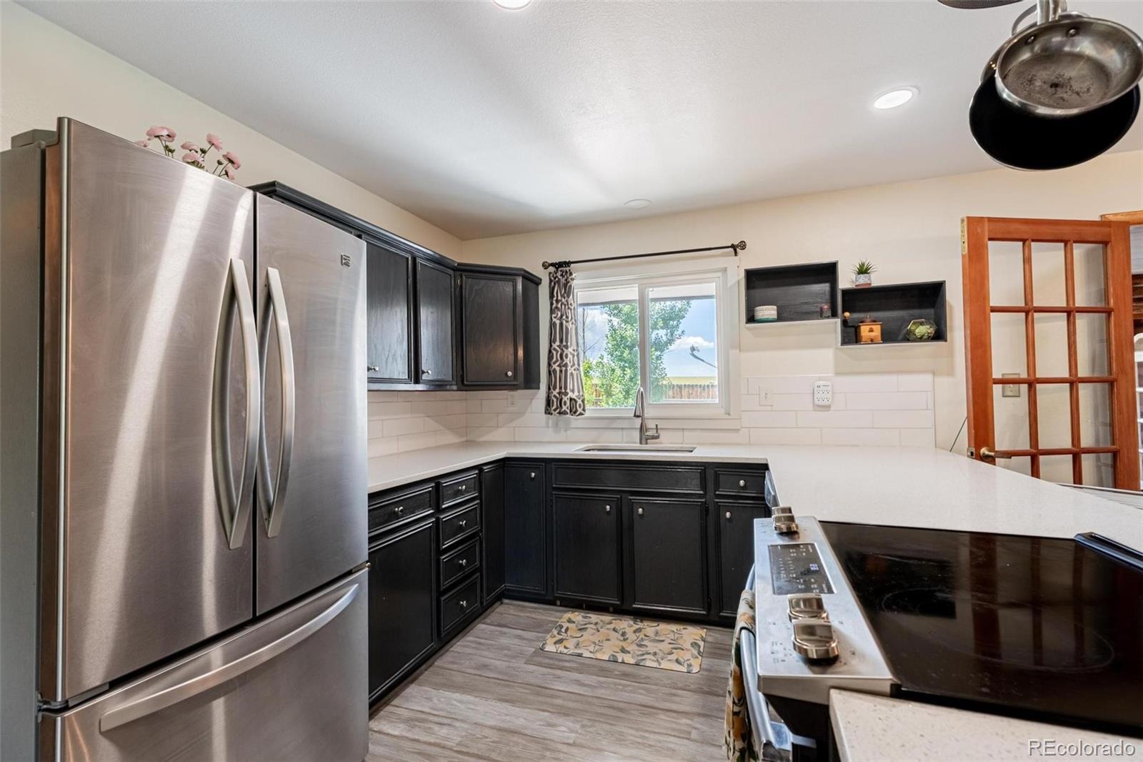 420 Clover Circle Hayden, CO 81639 - Photo 5 of 37 a kitchen with stainless steel appliances a refrigerator sink and stove
