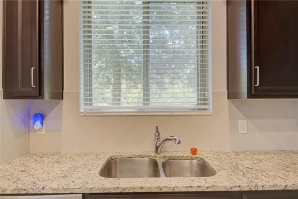 a bathroom with mirror sink and window