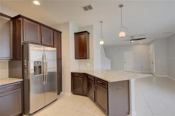 a kitchen with a refrigerator a sink and cabinets