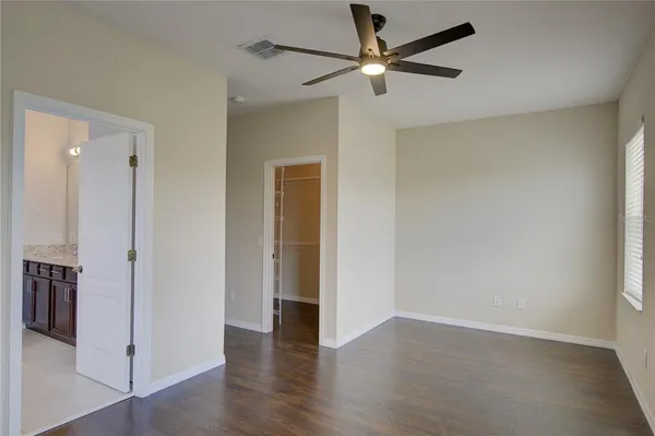 a view of an empty room with wooden floor