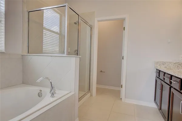 a bathroom with a bathtub and shower