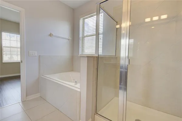 a white bath tub sitting next to a window