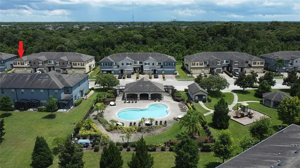 an aerial view of a house with outdoor space and a lake view