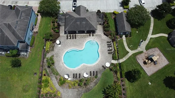 an aerial view of a house with a yard