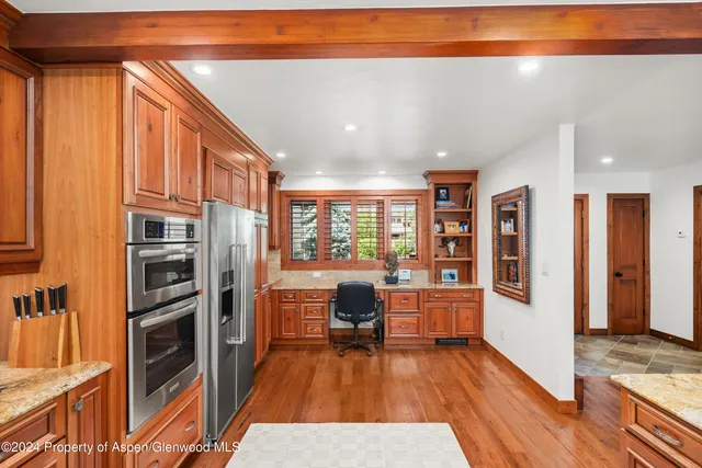 a kitchen with stainless steel appliances granite countertop a refrigerator and cabinets