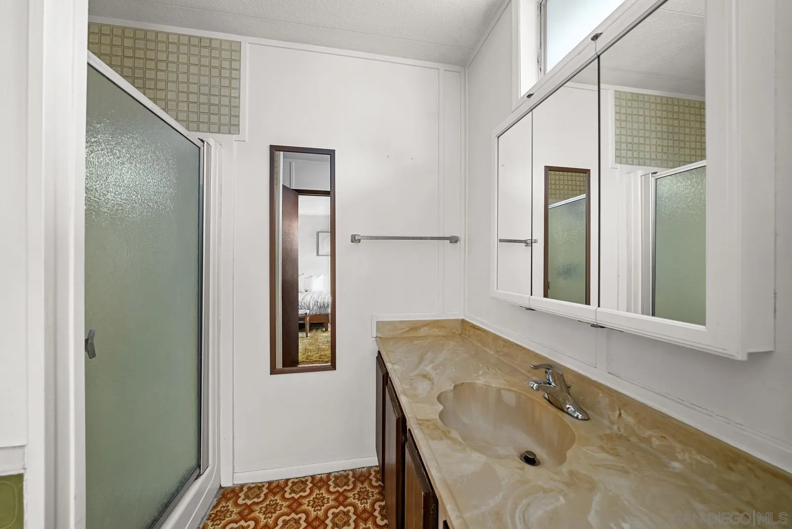 889 Galopago Street Spring Valley, CA 91977 - Photo 11 of 52 a bathroom with a sink and shower