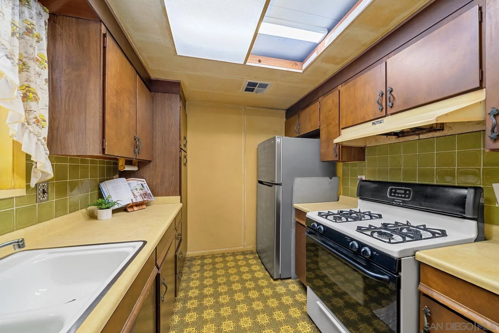 889 Galopago Street Spring Valley, CA 91977 - Photo 12 of 52 a kitchen with a sink a stove and refrigerator