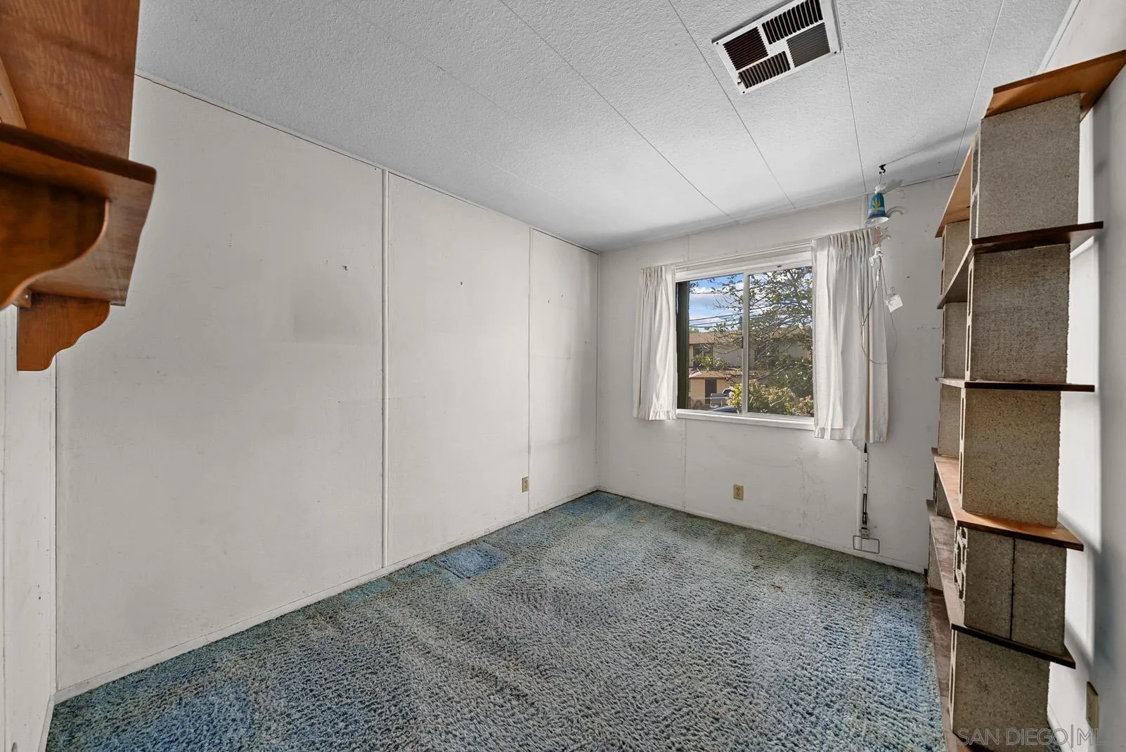 889 Galopago Street Spring Valley, CA 91977 - Photo 22 of 52 a view of an empty room with a window