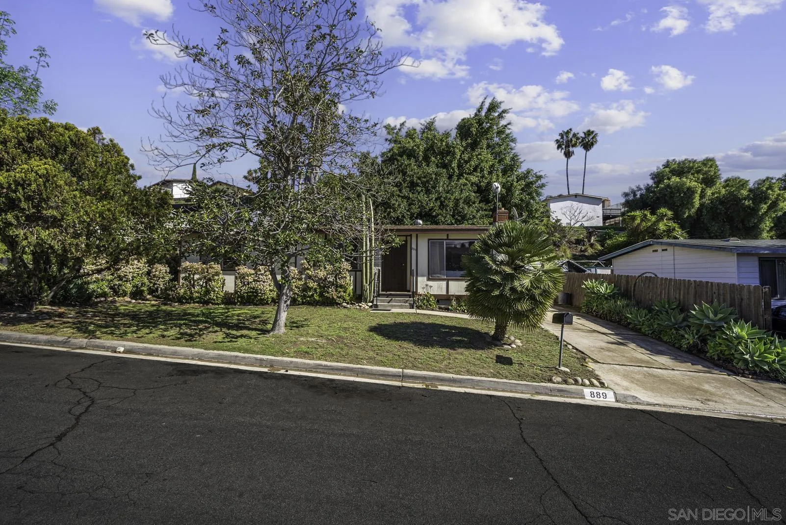 889 Galopago Street Spring Valley, CA 91977 - Photo 52 of 52 a front view of a house with a yard garage and outdoor seating