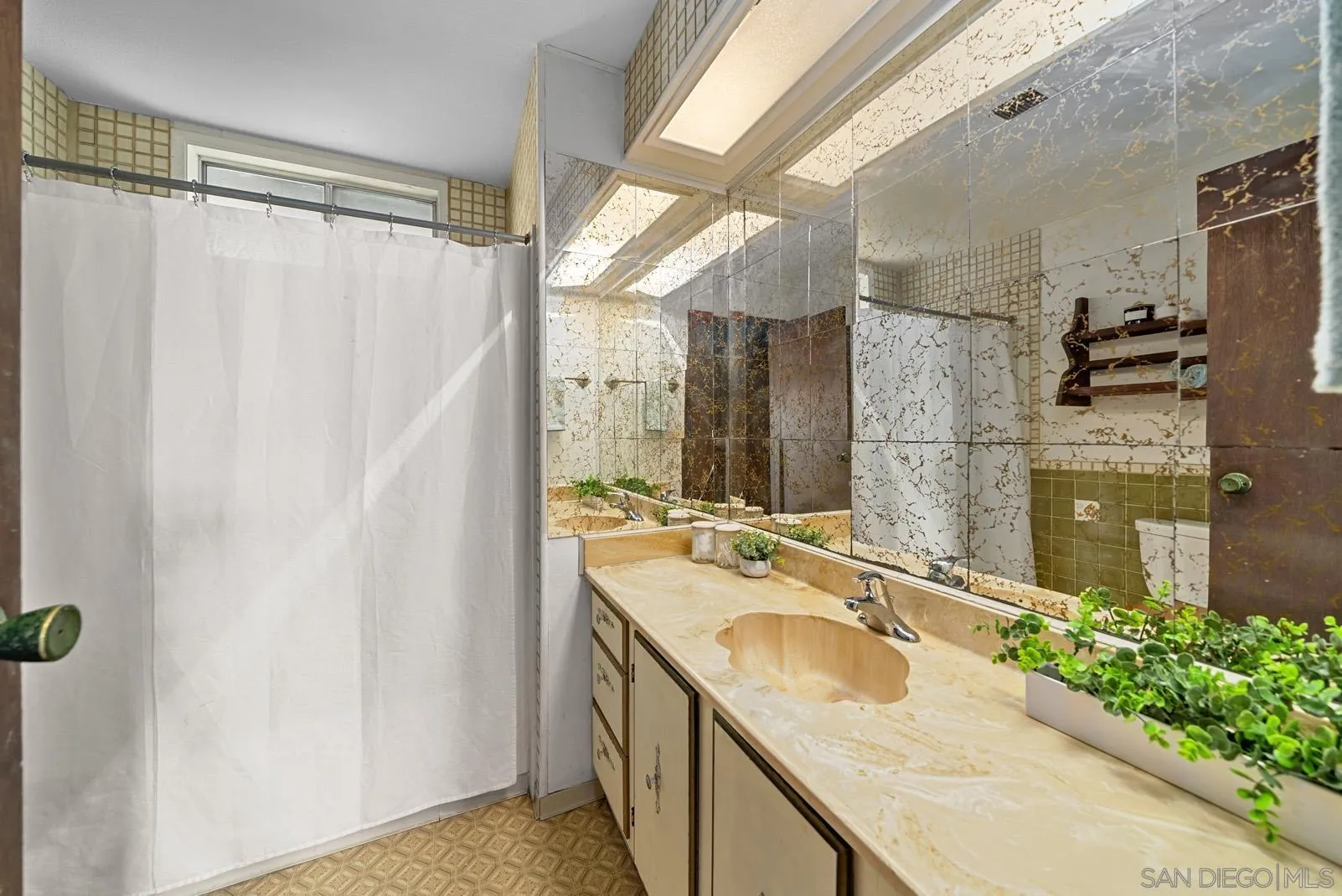 889 Galopago Street Spring Valley, CA 91977 - Photo 8 of 52 a bathroom with a granite countertop sink a mirror and shower