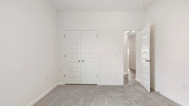 an empty room with closet area